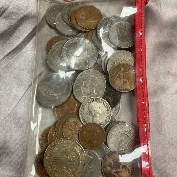 Assorted vintage coins including Liberty Dollars in a plastic bag.
