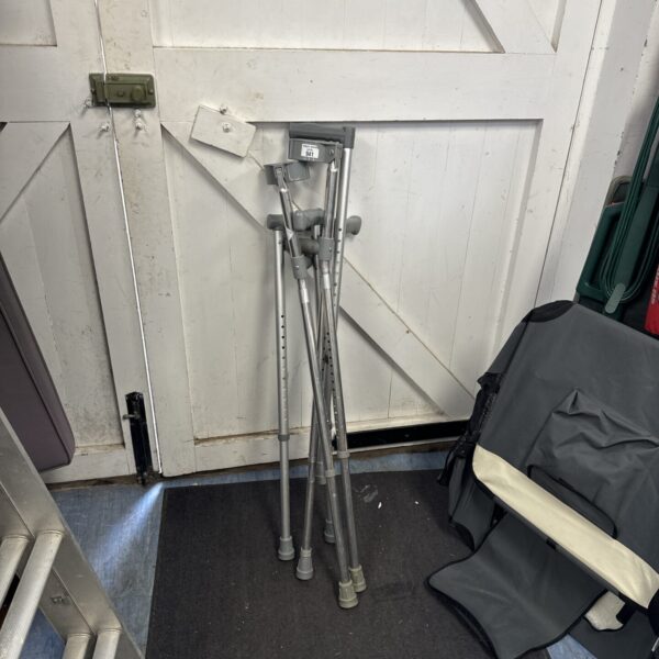 Bundle of adjustable crutches and walking aids for mobility support.