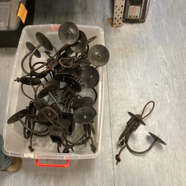 Vintage dual candle wall sconces in a storage box.