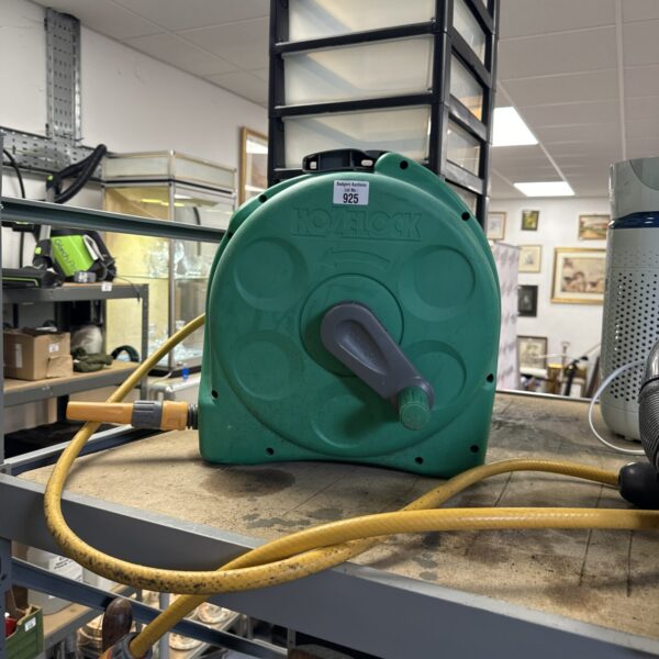 Green Hozelock hose reel for garden hose storage.
