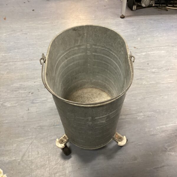 Vintage galvanised steel wheeled mop bucket for cleaning.