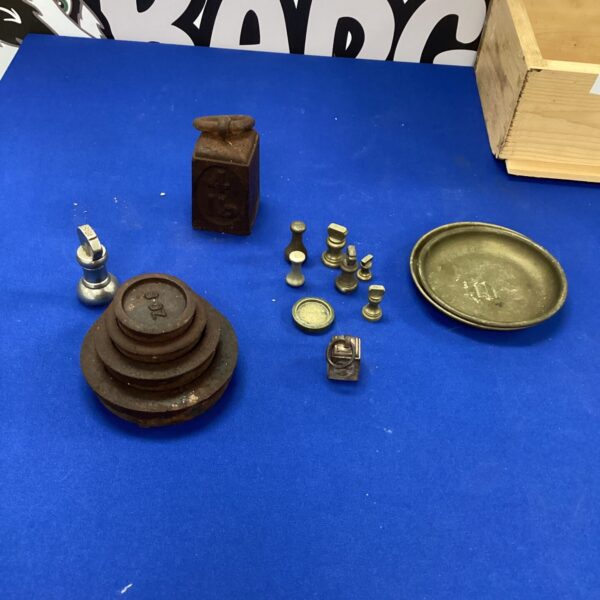 Vintage brass and iron weights for antique scales.