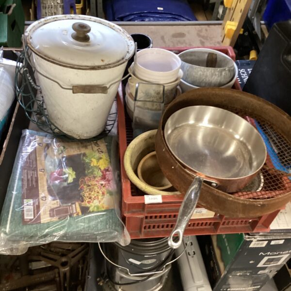 Assorted garden pots and metal sieve for gardening tasks.