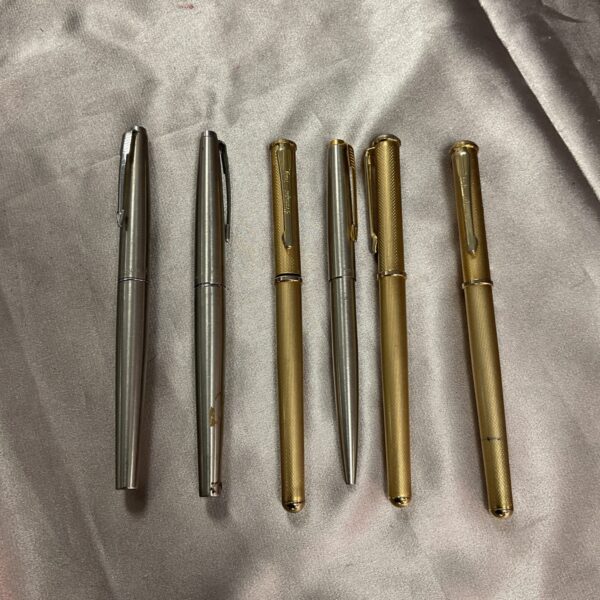 Six Parker pens in silver and gold tones, a vintage collection.