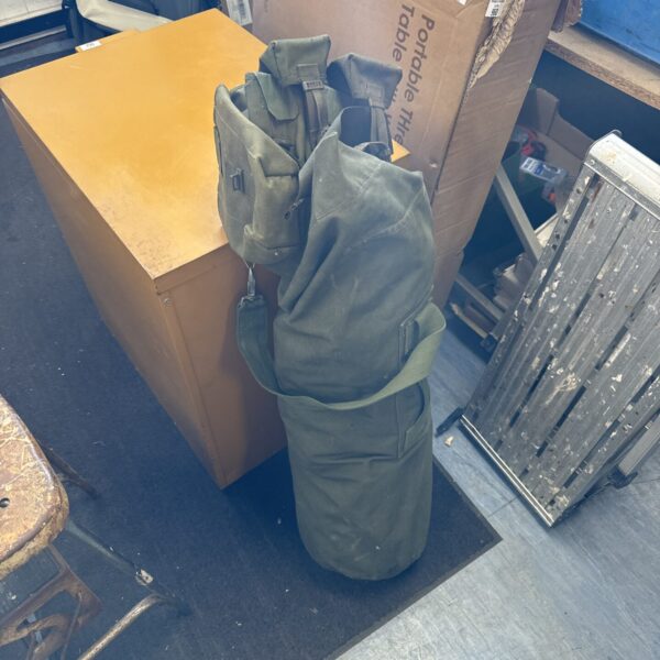 Vintage army kit bag with webbing and canvas construction.