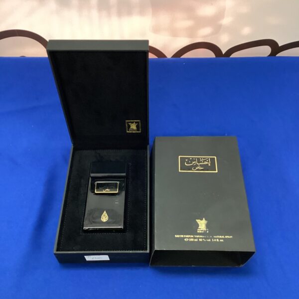 Vintage Arabian perfume spray in dark casing.