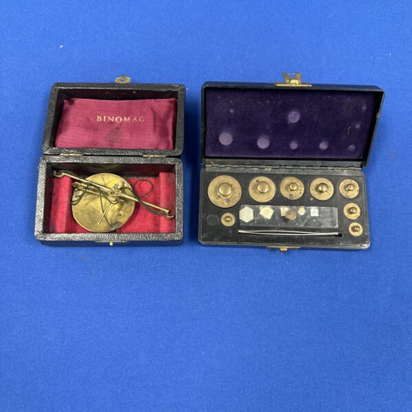 Vintage Binomag balance scales with weights in a case.