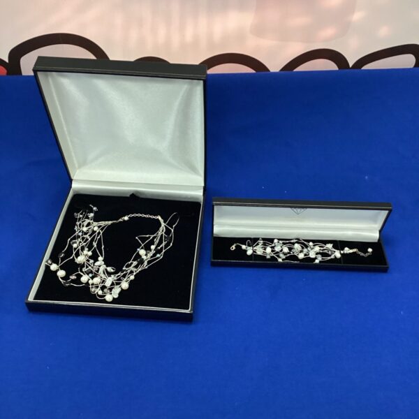 Elegant silver necklace and bracelet set in good condition.