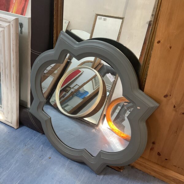 Ornate grey wall mirror with a vintage sculpted frame.