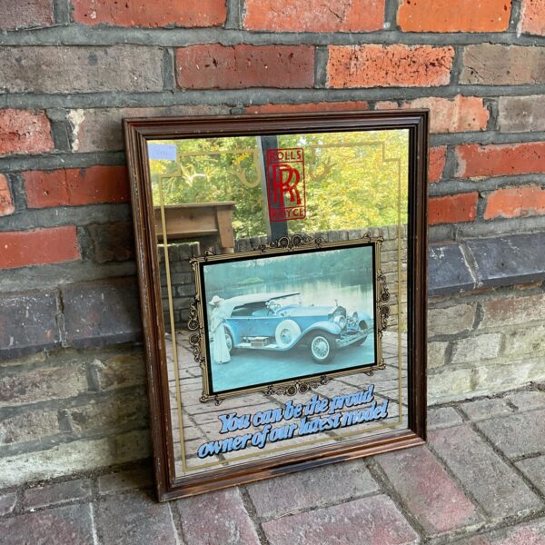 Vintage Rolls Royce pub mirror with classic car depiction.
