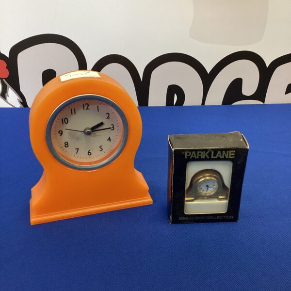 Vintage orange Park Lane mantle clock on display.