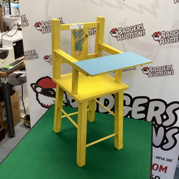 Bright yellow vintage baby chair, retro nursery furniture.