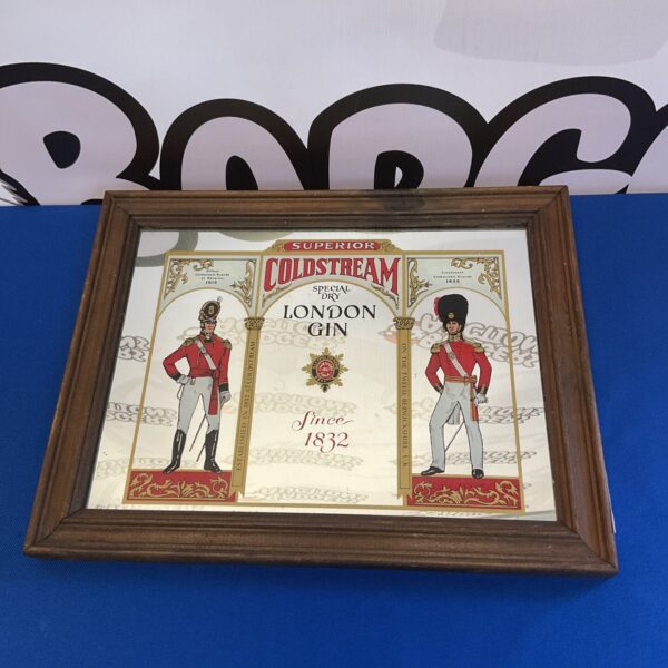 Vintage Coldstream Gin mirror with soldier illustration for pub decor.