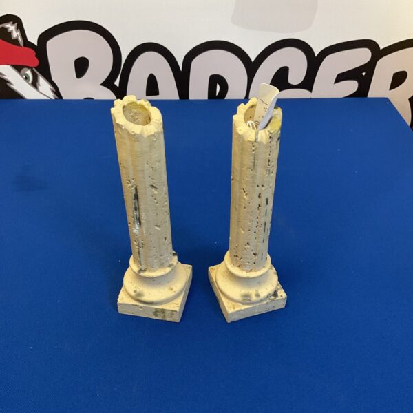 Pair of stone Corinthian column candle holders for elegant home decor.