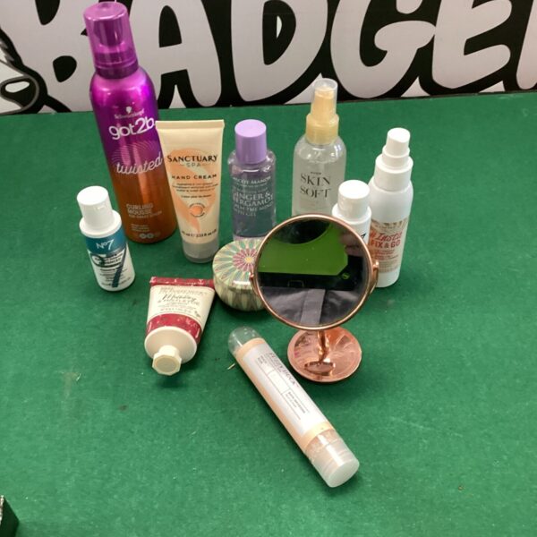 Tray of mixed cosmetic products including Schwarzkopf and Sanctuary brands.