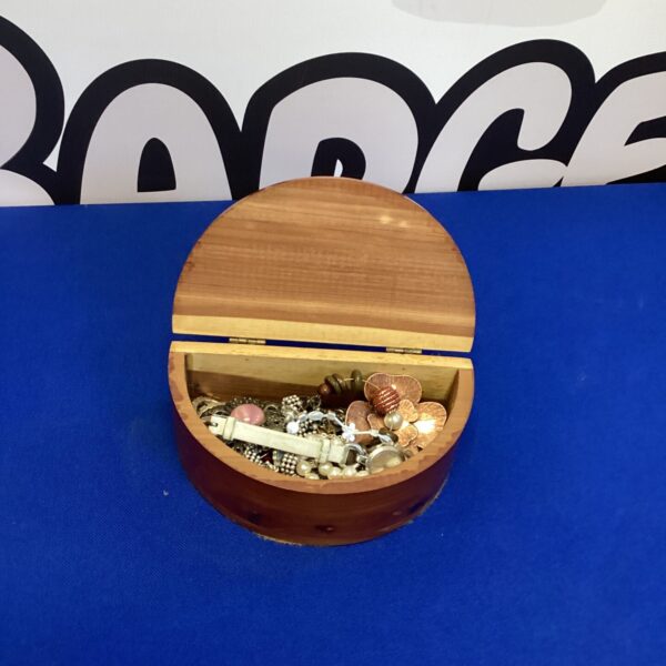 Vintage wooden jewellery box filled with jewellery and coins.