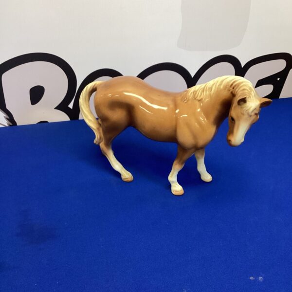Detailed porcelain horse figurine, a beautiful collectible for display.