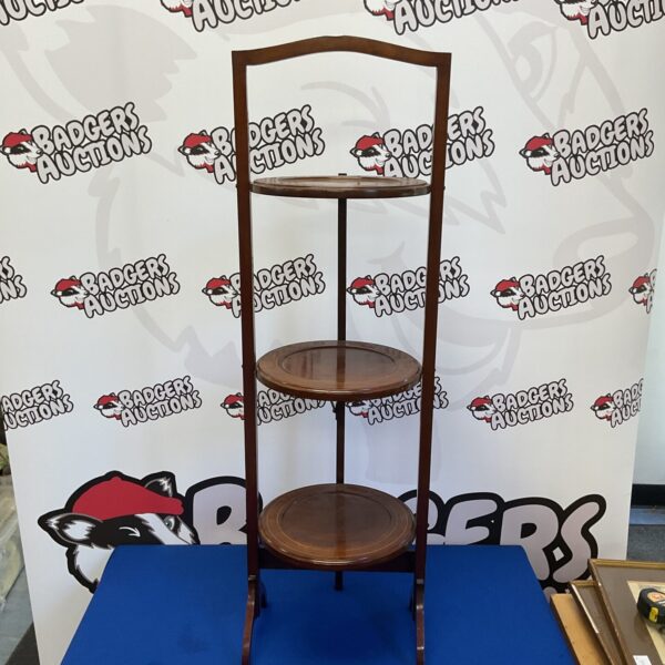 Vintage mahogany three-tier folding cake stand for display.
