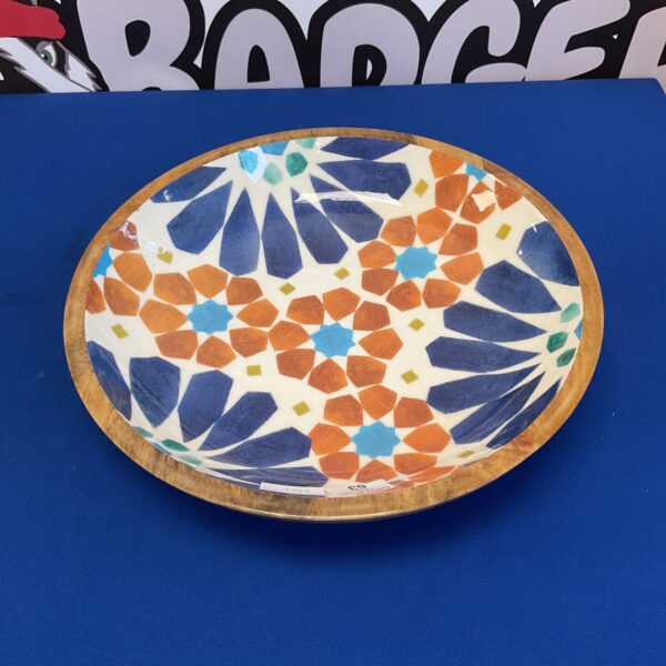 Colourful wooden fruit bowl with a geometric pattern.