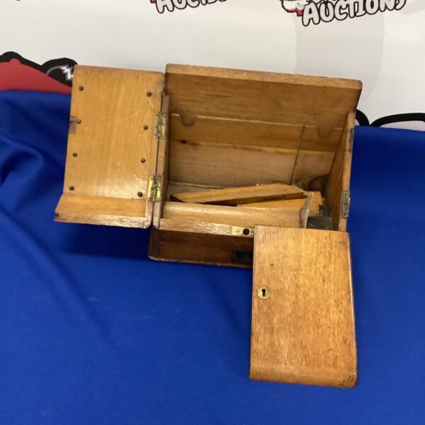 Front view of a vintage wooden stationery box for restoration.