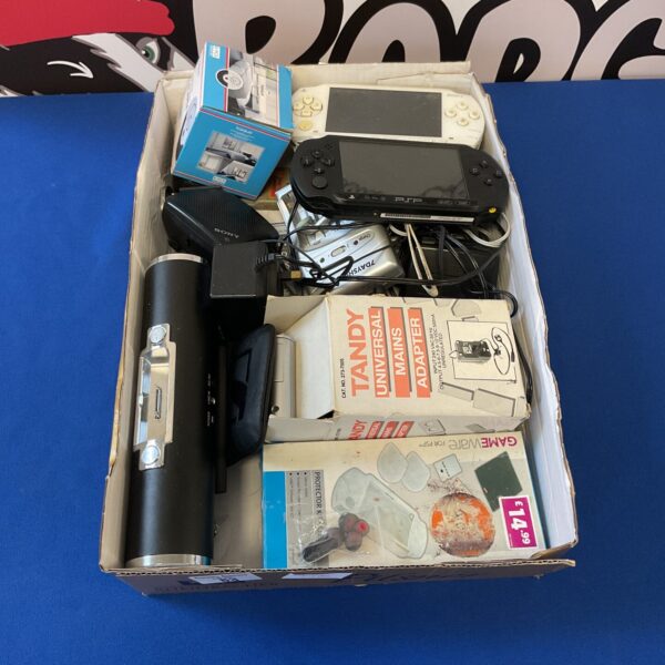 Mixed lot of PlayStation PSP consoles and electrical accessories.