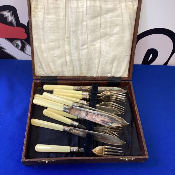 Vintage silverplate cutlery set with ribbed celluloid handles.