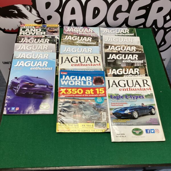 Stack of vintage Jaguar Enthusiast magazines for collectors.