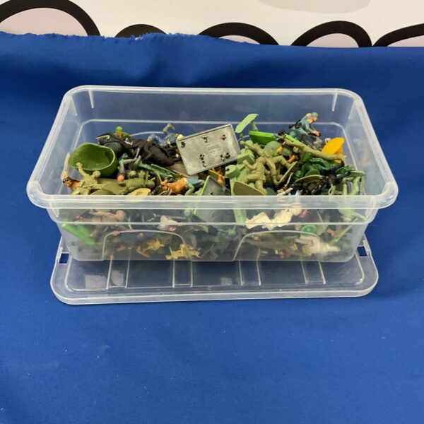 A box of mixed plastic army figurines for collectors.