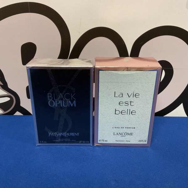 Sealed Yves Saint Laurent and Lancome perfume set, a luxurious fragrance duo.