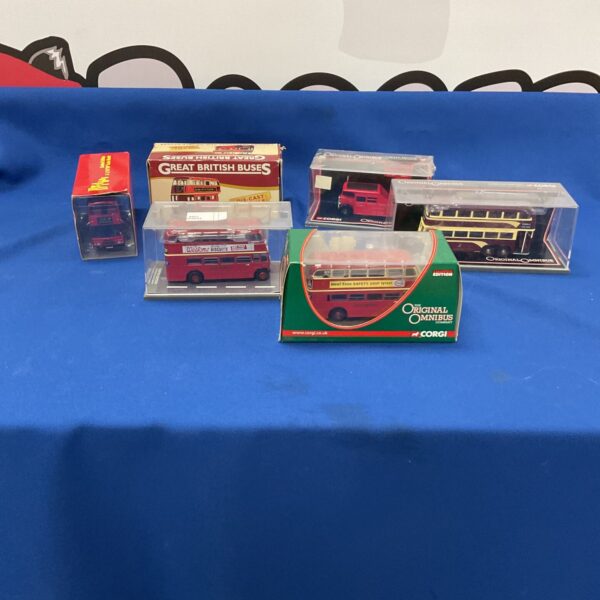 Vintage Corgy diecast buses in a lot for collectors.