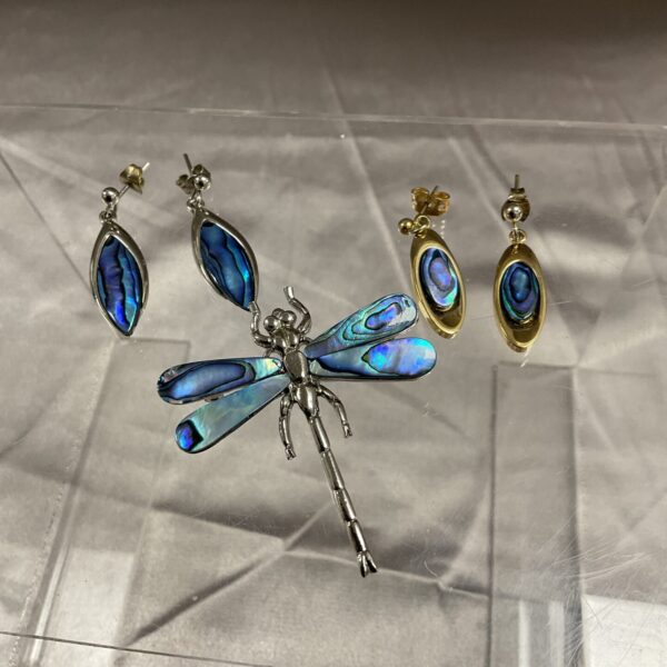 Close-up of Ariku paua shell dragonfly brooch and earrings set.