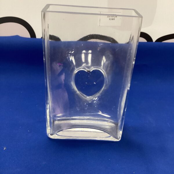 Clear glass heart vase for floral arrangements and home decor.