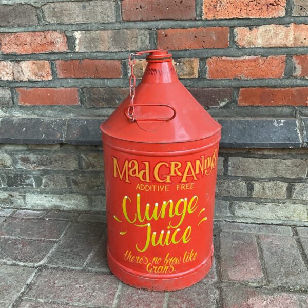 Vintage fuel can with "Mad Grannies Clunge Juice" hand-painted sign.