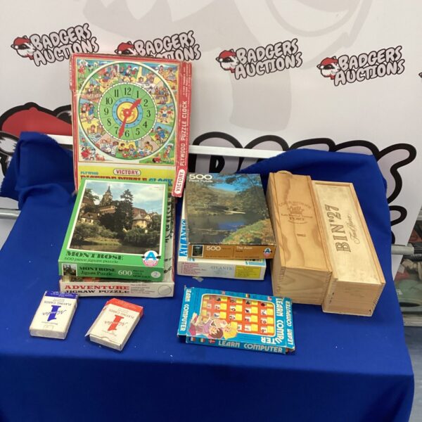 Vintage jigsaw puzzles and games lot, including a colourful box.
