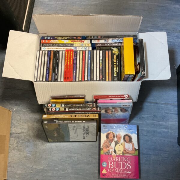 Mixed lot of DVDs, Blu-rays, and CDs for home entertainment.