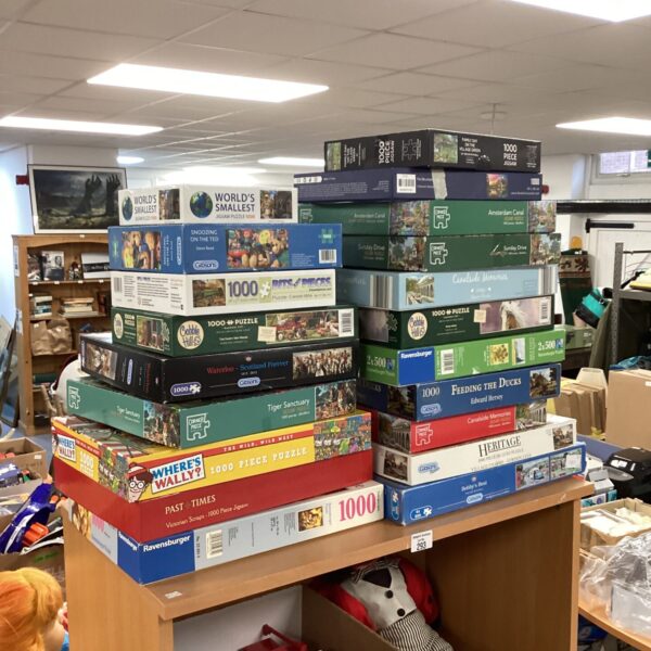 Large lot of assorted jigsaw puzzles, including Ravensburger brands.