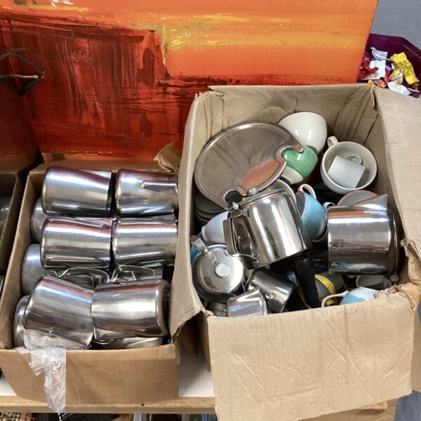 Stainless steel catering drinkware lot with jugs and mugs.