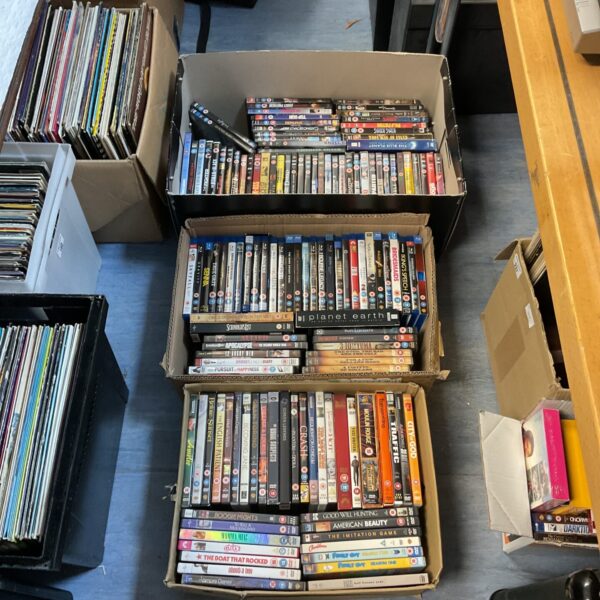 Three boxes filled with DVD and Blu-Ray movies for home entertainment.