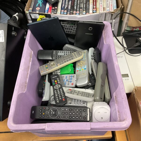 Mixed lot of remote controls and a tablet for sale.