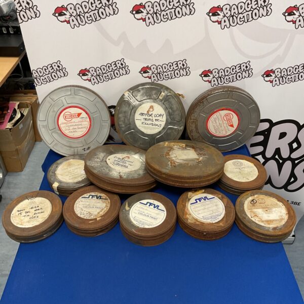 Vintage 16mm film reels in metal canisters, a collectible movie lot.