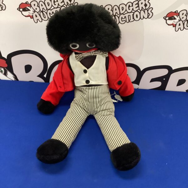 Vintage golly soft toy with red jacket and striped trousers.