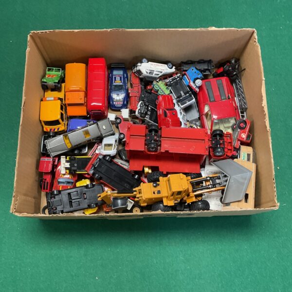 A box of vintage diecast model cars and vehicles.