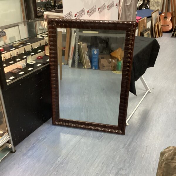 Large dark wood framed mirror for wall decor.