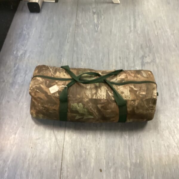 Camouflage one-person bivvy bag for outdoor survival.