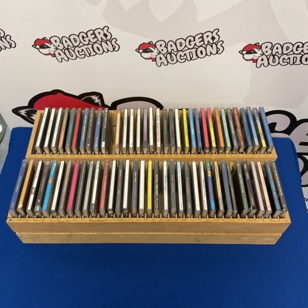 Vintage wooden CD storage racks displaying a collection of music CDs.