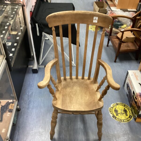 Traditional farmhouse carver chair with carved details.