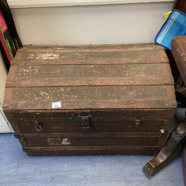 Vintage curved top travel trunk, antique luggage, collectible item.