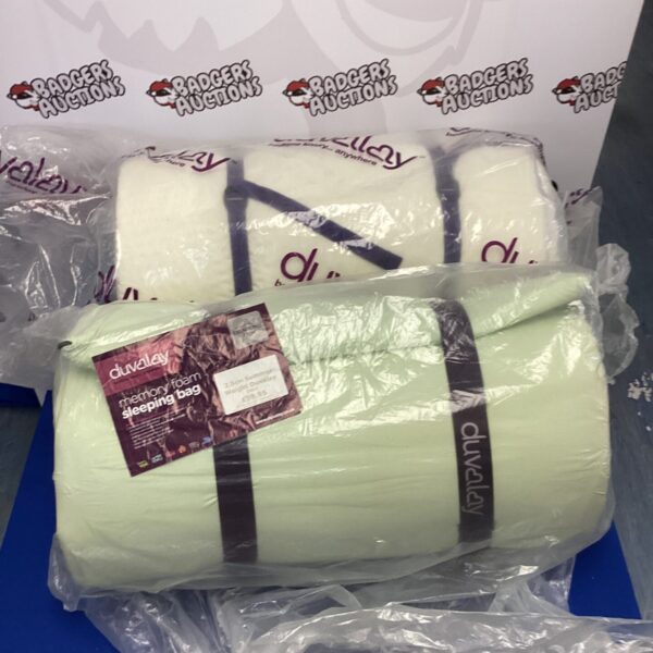 Two duvalay camping duvets rolled and secured with straps.