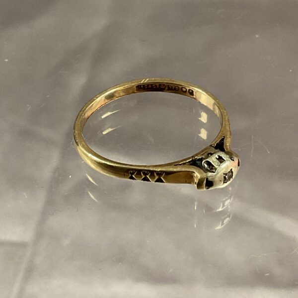 Close-up of a 9ct gold diamond ring, showcasing the sparkling stone.