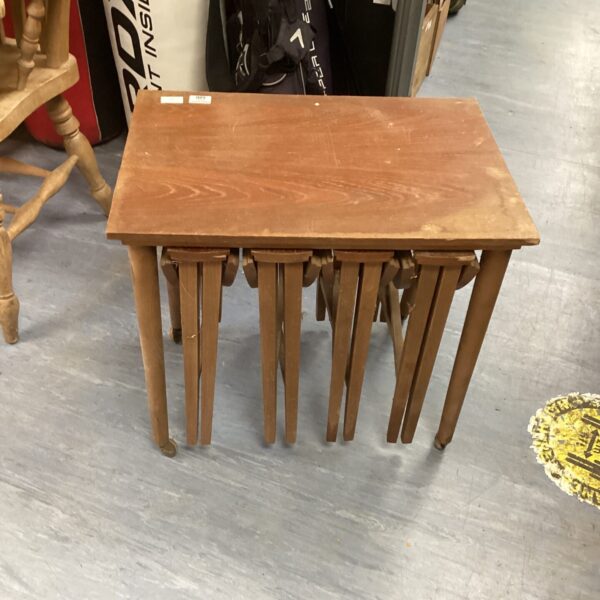 Vintage nest of tables in wood, side view.